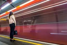 woman waiting by moving subway