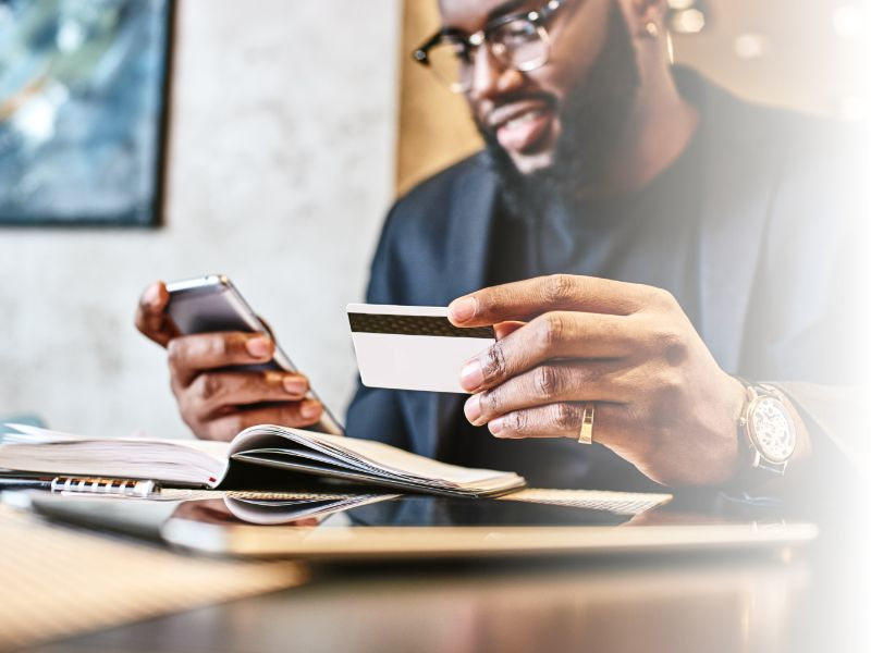 man buying on mobile phone with credit card