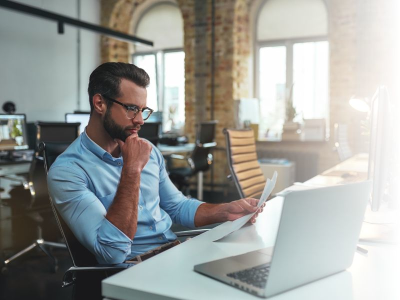 man working at desk with laptop